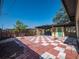 Landscaped backyard with covered patio and checkerboard pavers at 332 N Lakeland Ave, Orlando, FL 32805