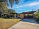 Exterior shot of the home and driveway with a covered parking space at 332 N Lakeland Ave, Orlando, FL 32805