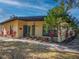 Charming single-story home with a well-manicured lawn and colorful plants accentuating the entryway at 332 N Lakeland Ave, Orlando, FL 32805
