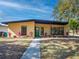 Inviting single-story home with vibrant landscaping and a walkway leading to a charming green front door at 332 N Lakeland Ave, Orlando, FL 32805
