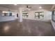 Bright, open living room with terrazzo flooring, large windows, and a ceiling fan at 332 N Lakeland Ave, Orlando, FL 32805