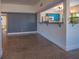 Open concept living space with terrazzo floors, blue accent wall, and view of the kitchen at 332 N Lakeland Ave, Orlando, FL 32805
