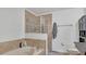 Bathroom with soaking tub, walk-in shower, and tile surround at 3813 Black Spruce Ln, Winter Springs, FL 32708