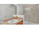 Bathroom featuring a shower-tub combo with a clear glass shower door at 3813 Black Spruce Ln, Winter Springs, FL 32708