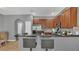 Kitchen features granite counters, tile floors, stainless appliances, and breakfast bar at 3813 Black Spruce Ln, Winter Springs, FL 32708