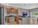 Kitchen features granite counters, tile floors, stainless appliances, and breakfast bar at 3813 Black Spruce Ln, Winter Springs, FL 32708