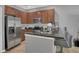 Well-lit kitchen features stainless steel appliances, granite countertops, and breakfast bar at 3813 Black Spruce Ln, Winter Springs, FL 32708
