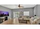 Comfortable living room featuring neutral tones, tile floors, and a sliding glass door that provides natural light at 3813 Black Spruce Ln, Winter Springs, FL 32708