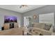 Comfortable living room featuring neutral tones, tile floors, and a sliding glass door that provides natural light at 3813 Black Spruce Ln, Winter Springs, FL 32708