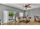 Comfortable living room featuring neutral tones, tile floors, and a sliding glass door that provides natural light at 3813 Black Spruce Ln, Winter Springs, FL 32708