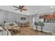An open concept living space featuring a dining room with wood table, kitchen with bar seating, and comfortable seating area at 3813 Black Spruce Ln, Winter Springs, FL 32708