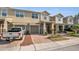 Inviting townhome featuring a private garage and charming front landscaping, showcasing a comfortable and appealing exterior at 3813 Black Spruce Ln, Winter Springs, FL 32708