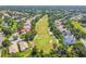 Aerial view of a home with a golf course view, mature trees, and well-manicured landscaping at 404 Sotheby Way, Debary, FL 32713