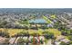 Aerial view of a home surrounded by mature trees and a beautiful pond in a residential neighborhood at 404 Sotheby Way, Debary, FL 32713