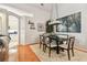 Inviting dining area featuring hardwood floors, modern chandelier, and easy access to kitchen at 404 Sotheby Way, Debary, FL 32713
