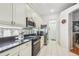 Efficient kitchen with granite countertops, black appliances, and ample cabinet storage at 404 Sotheby Way, Debary, FL 32713