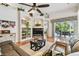 Bright living space with hardwood floors, built-in shelving, and sliding doors leading to outdoor patio at 404 Sotheby Way, Debary, FL 32713