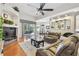 Cozy living room with hardwood floors, plush sofa, and sliding glass doors to the outdoor space at 404 Sotheby Way, Debary, FL 32713