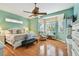 Well-lit main bedroom features bay windows, a ceiling fan, and a sitting area at 404 Sotheby Way, Debary, FL 32713