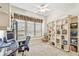 Inviting home office space with built-in bookshelves and a comfortable workspace at 404 Sotheby Way, Debary, FL 32713