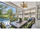 Screened-in patio with a ceiling fan, comfortable seating, and a view of the pool at 404 Sotheby Way, Debary, FL 32713