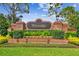 Landscaped brick community sign with black and gold 'Westridge' lettering, decorative lighting, and beautiful foliage at 404 Sotheby Way, Debary, FL 32713