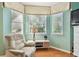 Bright sitting area with a recliner, side table, and a large bay window at 404 Sotheby Way, Debary, FL 32713