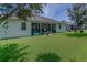 Backyard with covered patio, green lawn, and attractive house elevation at 410 E Victoria Trails Blvd, Deland, FL 32724