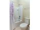 Clean bathroom with a shower-tub combination and floral shower curtain at 410 E Victoria Trails Blvd, Deland, FL 32724