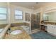 Well-lit bathroom with separate shower, bathtub, dual sinks, and granite countertops at 410 E Victoria Trails Blvd, Deland, FL 32724