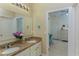 Bright bathroom featuring a double sink vanity with granite countertops and decorative accents at 410 E Victoria Trails Blvd, Deland, FL 32724