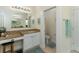 Well-lit bathroom with a vanity, granite countertop, vanity seating, and an adjacent water closet at 410 E Victoria Trails Blvd, Deland, FL 32724