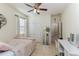 Cozy bedroom features a ceiling fan, large closet, and tile flooring at 410 E Victoria Trails Blvd, Deland, FL 32724