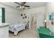 Inviting bedroom with tile floors, a ceiling fan, and a comfortable bed with bright bedding at 410 E Victoria Trails Blvd, Deland, FL 32724