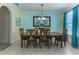 Inviting dining room with a large mirror, chandelier, and wooden table for gatherings at 410 E Victoria Trails Blvd, Deland, FL 32724