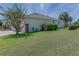Exterior home view showcasing lush lawn and partial stone facade at 410 E Victoria Trails Blvd, Deland, FL 32724