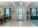 Bright foyer with tile flooring, elegant chandelier, and views into adjacent living spaces at 410 E Victoria Trails Blvd, Deland, FL 32724
