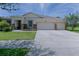 Delightful single-Gathering home featuring a two-car garage, attractive stone accents, and a neatly landscaped front yard at 410 E Victoria Trails Blvd, Deland, FL 32724