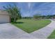 Well-maintained front yard with lush grass and landscaping with sidewalk to front door at 410 E Victoria Trails Blvd, Deland, FL 32724