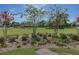 Beautifully landscaped front yard with mature trees and green grass at 410 E Victoria Trails Blvd, Deland, FL 32724