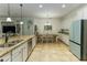 Spacious kitchen with white cabinets, granite countertops, stainless steel appliances, and tile flooring at 410 E Victoria Trails Blvd, Deland, FL 32724