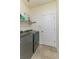 Laundry room features new front load washer and dryer and tiled floors at 410 E Victoria Trails Blvd, Deland, FL 32724