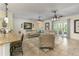 Comfortable living room with tile flooring, a large sofa, and seamless flow to the outdoor area at 410 E Victoria Trails Blvd, Deland, FL 32724