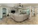 Spacious living room featuring tile flooring, a large sectional sofa, and an entertainment center at 410 E Victoria Trails Blvd, Deland, FL 32724
