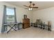 Spacious living room with a ceiling fan, tile floor, and large window at 410 E Victoria Trails Blvd, Deland, FL 32724