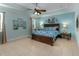 Serene main bedroom with blue walls, tray ceiling, and large bed with matching linens at 410 E Victoria Trails Blvd, Deland, FL 32724
