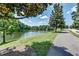 Scenic view of the pond with lush greenery, trees, and walking path at 410 E Victoria Trails Blvd, Deland, FL 32724