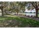 Scenic view of the community pond surrounded by lush green grass and mature trees at 410 E Victoria Trails Blvd, Deland, FL 32724