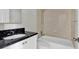 Bathroom with black granite vanity, tiled shower, and toilet at 416 Banyon Tree Cir # 108, Maitland, FL 32751