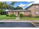 Charming brick home with lush lawn, featuring a palm tree and colorful peach shutters at 416 Banyon Tree Cir # 108, Maitland, FL 32751